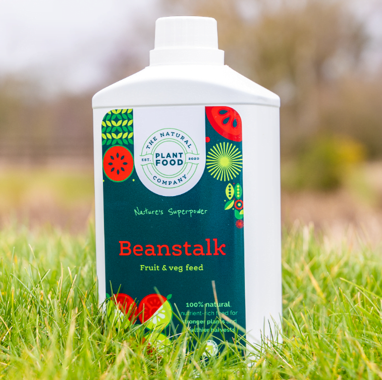 Beanstalk 1L bottle standing in long grass